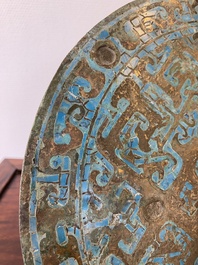 A large Chinese bronze mirror with turquoise and gold or gilt silver inlays, Warring States Period