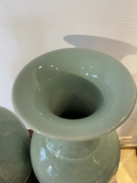 Een paar Chinese monochrome celadon vazen met onderglazuur decor op houten sokkels, Qianlong merk, 18/19e eeuw