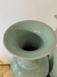 Een paar Chinese monochrome celadon vazen met onderglazuur decor op houten sokkels, Qianlong merk, 18/19e eeuw