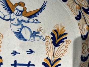 An exceptional polychrome Dutch maiolica dish with a flying putto above a fence, probably Haarlem, 1st half 17th C.