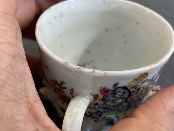 A pair of Chinese famille rose relief-decorated cups and saucers, Yongzheng