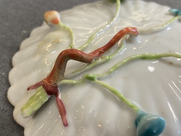 A pair of Chinese famille rose relief-decorated cups and saucers, Yongzheng