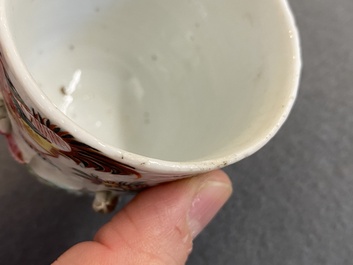 A pair of Chinese famille rose relief-decorated cups and saucers, Yongzheng