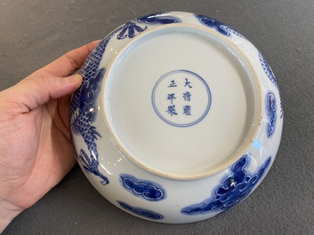 A Chinese blue and white plate with a dragon chasing the flaming pearl, Yongzheng mark and of the period