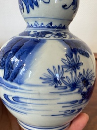 A Chinese blue and white double gourd vase with a scholar and two students, Transitional period
