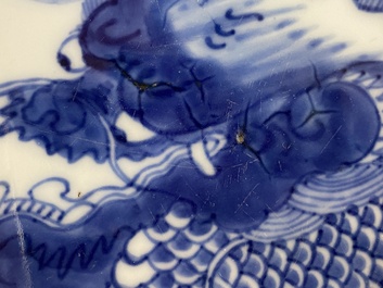 A Chinese blue and white plate with a dragon chasing the flaming pearl, Yongzheng mark and of the period