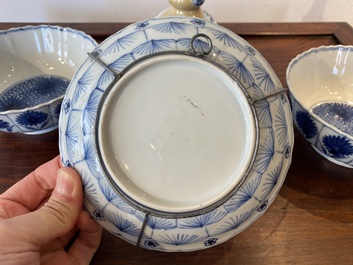 Two Chinese blue and white bowls, a small plate and a caf&eacute;-au-lait ground sprinkler, Kangxi