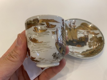 A rare Chinese gilt, grisaille and iron-red cup and saucer with a merchant vessel, Yongzheng/Qianlong