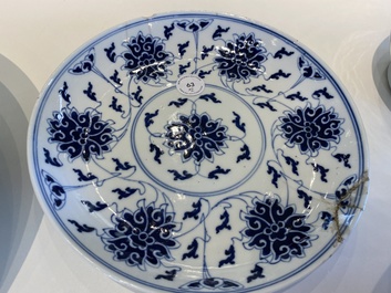 Un plat en porcelaine de Chine famille rose aux '100 chauve-souris' et une assiette &agrave; d&eacute;cor de lotus en bleu et blanc, marque et &eacute;poque de Guangxu