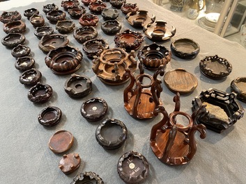 71 Chinese well-carved wooden stands, 19/20th C.