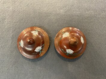 A pair of Chinese famille rose ruby-ground vases and covers, Yongzheng/Qianlong