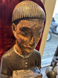 A partly gilded and polychromed wood sculpture of a monk holding a chest, probably Spain, 16th C.