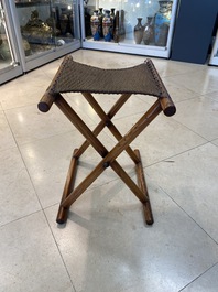 A Chinese wooden mirror and a foldable stool, 19/20th C.