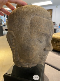 A Khmer stone head of Jayavarman VII in Bayon-style, Cambodia, probably 13th C.