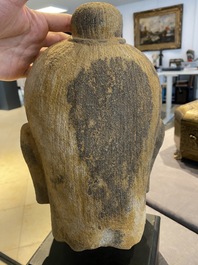 A Khmer stone head of Jayavarman VII in Bayon-style, Cambodia, probably 13th C.