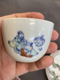 Four Chinese saucers and three cups in blue and white, doucai and famille rose porcelain, Kangxi and later