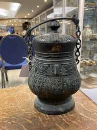 A Chinese archaic bronze ritual 'you' wine vessel and cover in Western Zhou-style, Ming