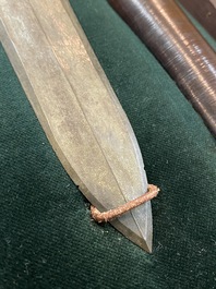 A Chinese bronze dagger with wooden scabbard in a display case, Han