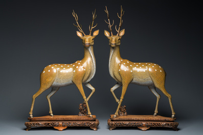 A very fine and large pair of Chinese cloisonn&eacute; models of deer on reticulated wooden stands, 19th C.