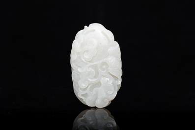 A Chinese white jade paper weight with a crane and a tiger, 17/18th C.