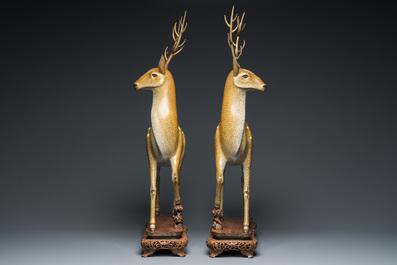 A very fine and large pair of Chinese cloisonn&eacute; models of deer on reticulated wooden stands, 19th C.