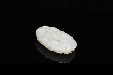 A Chinese white jade paper weight with a crane and a tiger, 17/18th C.