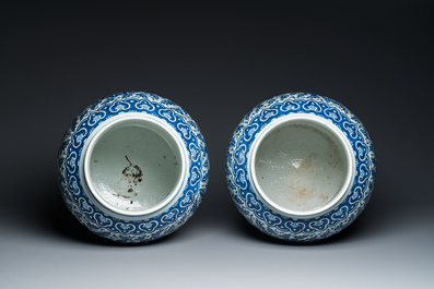 A pair of large Chinese blue and white 'lotus scroll' vases and covers, 19th C.