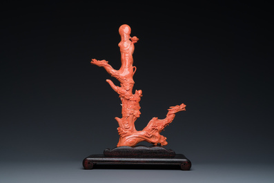 A Chinese red coral figure of a standing Bodhisattva with two dragons, 19/20th C.