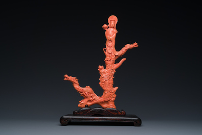 A Chinese red coral figure of a standing Bodhisattva with two dragons, 19/20th C.