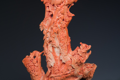 A large Chinese red coral group of a lady holding a cornucopia surrounded by children, 19/20th C.