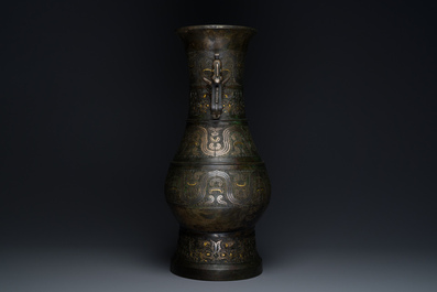 An imposing Chinese archaic gold-and-silver-inlaid bronze 'hu' vase on wooden stand inscribed Tao Xiang 陶湘 and Luo Zhenyu 羅振玉, Song/Ming