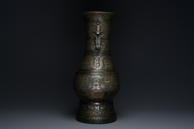 An imposing Chinese archaic gold-and-silver-inlaid bronze 'hu' vase on wooden stand inscribed Tao Xiang 陶湘 and Luo Zhenyu 羅振玉, Song/Ming
