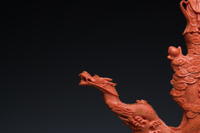 A Chinese red coral figure of a standing Bodhisattva with two dragons, 19/20th C.