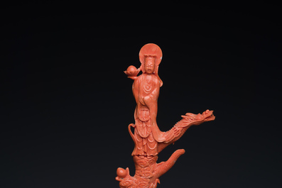 A Chinese red coral figure of a standing Bodhisattva with two dragons, 19/20th C.