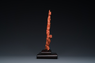 A Chinese red coral figure of a standing Bodhisattva with two dragons, 19/20th C.