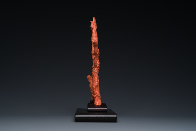 A Chinese red coral figure of a standing Bodhisattva with two dragons, 19/20th C.