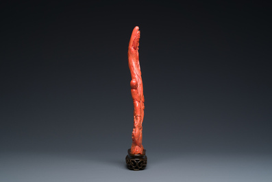 A Chinese red coral group of a standing Guanyin with a boy on a lotus flower, 19/20th C.