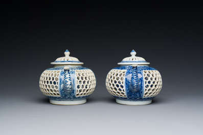 A pair of Chinese reticulated and double-walled blue and white teapots, Transitional period