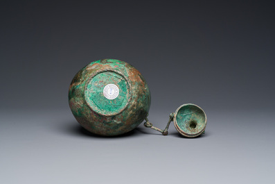 A rare archaic Chinese bronze gourd-shaped vase and cover, 'hu', Eastern Zhou