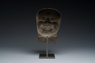 A Tibetan cast iron 'Mahakala' mask, 16/17th C.