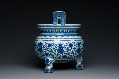 A large Chinese blue and white 'bajixiang' tripod censer with lotus scrolls, Qianlong