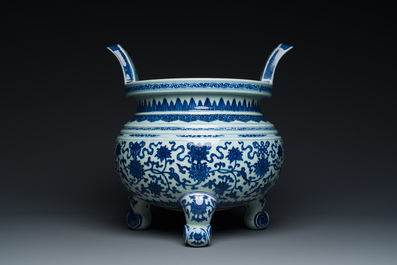 A large Chinese blue and white 'bajixiang' tripod censer with lotus scrolls, Qianlong