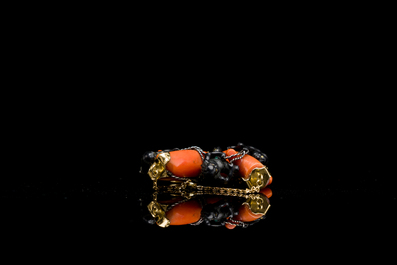 A rare Japanese gold and silver pendant with three South Sea-islanders on a coral branch, Meiji, 19th C.