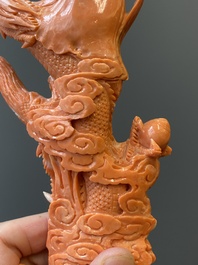 A Chinese red coral figure of a standing Bodhisattva with two dragons, 19/20th C.