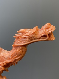 A Chinese red coral figure of a standing Bodhisattva with two dragons, 19/20th C.