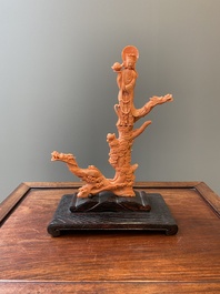 A Chinese red coral figure of a standing Bodhisattva with two dragons, 19/20th C.