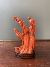 A Chinese red coral group of two ladies and a phoenix, 19/20th C.