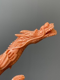 A Chinese red coral figure of a standing Bodhisattva with two dragons, 19/20th C.