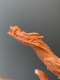 A Chinese red coral figure of a standing Bodhisattva with two dragons, 19/20th C.