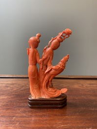 A Chinese red coral group of two ladies and a phoenix, 19/20th C.